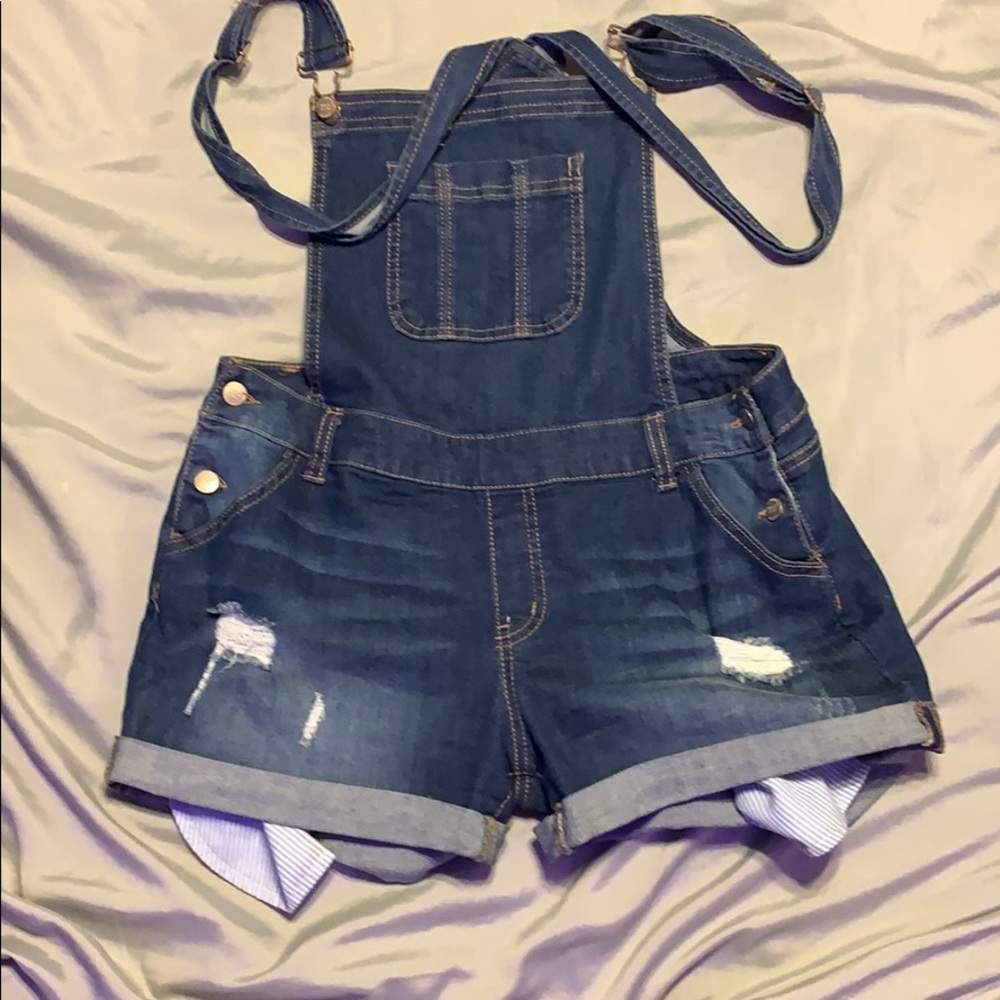 Medium blue stretchy denim overall shorts.
